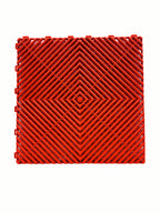 Red interlocking plastic floor grate for car washes, garages, or playgrounds with diamond pattern
